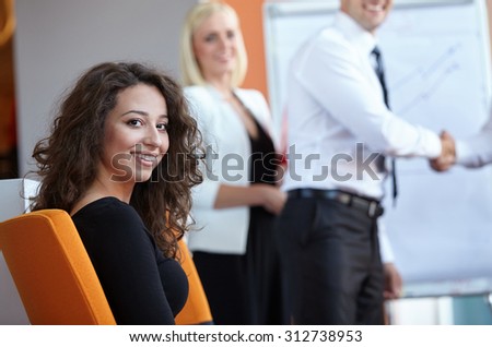 businessman shaking hands to seal a deal with his partner and colleagues in a modern office