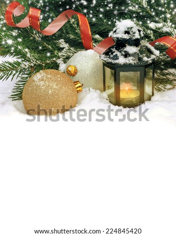 Christmas balls and magic lantern in the snow on a background of the Christmas tree