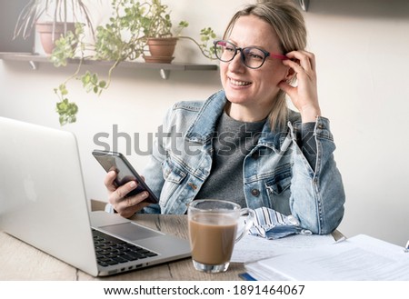 Nice business woman in a cozy workplace works with pleasure