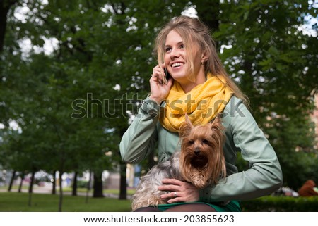 Happy young blonde speaking the cellphone with her friend, concept of friendship and communications.