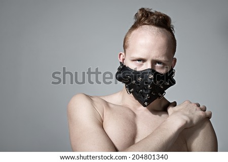 redhead fashion man model in muzzle. Concept of Freedom of speech, censorship, restriction and silent. Copy space.