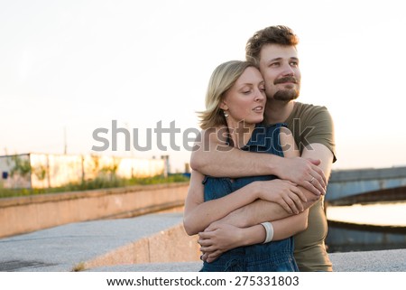 pretty couple embrace outdoor. Handsome bearded man and beautiful slim pretty blonde