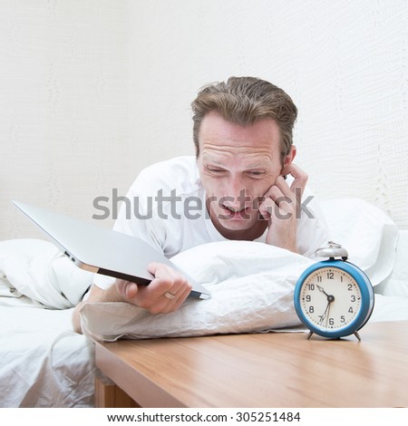 hard morning, man overslept, scratching his stubble, wake up and  grab his laptop to run for work