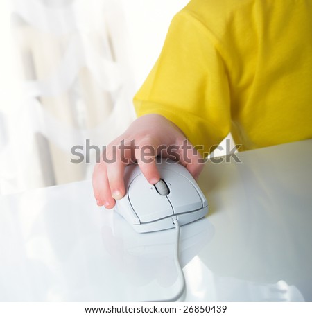 little boy using a mouse on white background