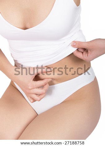 The girl measures fat on a stomach on a white background
