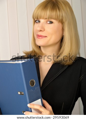 Folder for papers in hands at business of the woman in black clothes