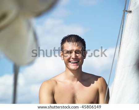 Portrait young men on a yacht near a sail