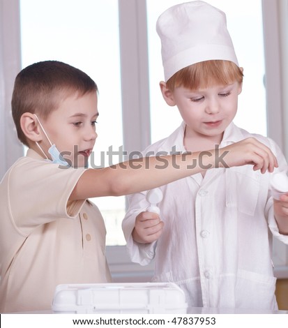 Small children play hospital and doctor