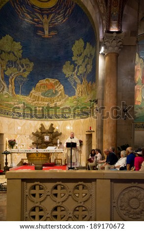 JERUSALEM, ISRAEL - APRIL, 21, 2014 : Orthodox priest gives sermon of Easter Sunday inside the  Church of All Nations in Jerusalem, Israel on April, 21, 2014.