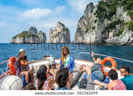 CAPRI, ITALY - MAY 08, 2015 : Unidentified tourists on cruise boat round the isle of Capri, Italy.