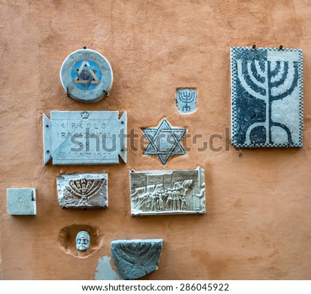 ROME, ITALY - MAY 05, 2015 : Jewish symbols on the wall of Jewish district in Rome, Italy.