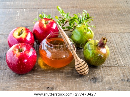 Honey, apples and pomegranates on wood deck  for Rosh Hashana celebration.