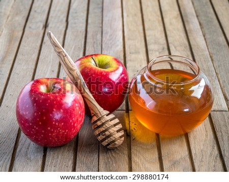 Honey and  apples on wood deck for Rosh Ha Shana celebration.
