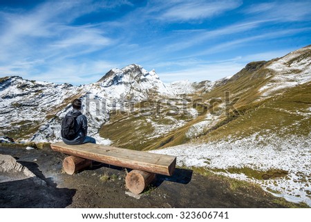 Wood bench at hiking pass above Grindelwald from First cable car to Bachalpsee - beautiful mountain lake.
