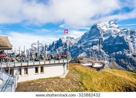 GRINDELWALD, Switzerland - SEPTEMBER 25, 2015 : Unknown tourists at mountain restaurant on top station of  First cable car above  Grindelwald, Switzerland.