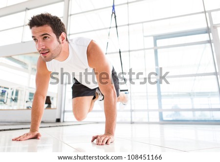 Handsome fit man exercising a the gym