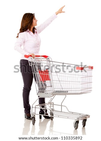 Woman with a shopping cart reaching for something - isolated over white