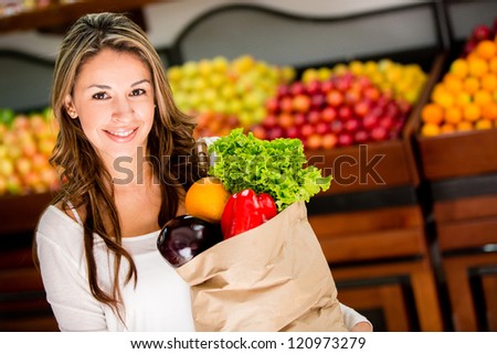 Casual woman grocery shopping and looking happy