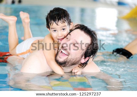 Father and son in pool