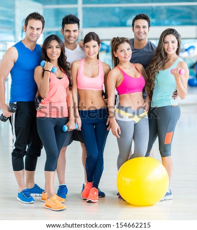 Happy group of fit people at the gym 
