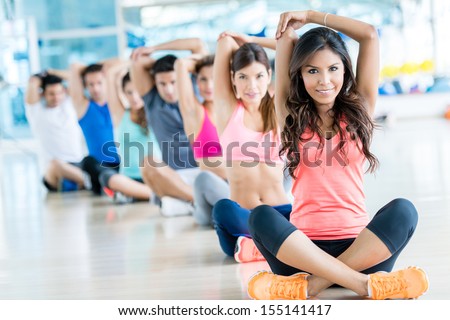 Group of fit people at the gym exercising 