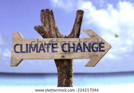 Climate Change wooden sign with a beach on background