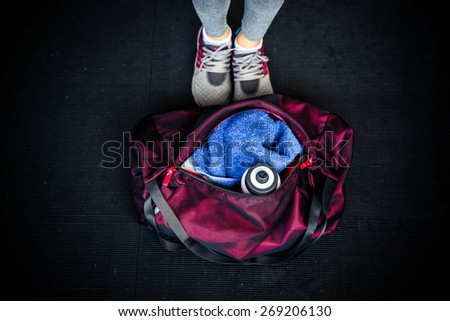 Closeup image of fitness bag with female legs