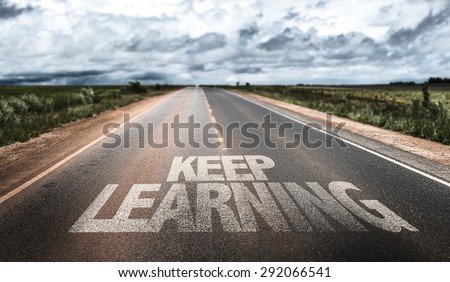 Keep Learning written on rural road