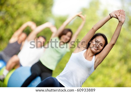 Group of people in a pilates class outdoors