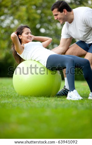 Fit woman and her sports trainer exercising outdoors