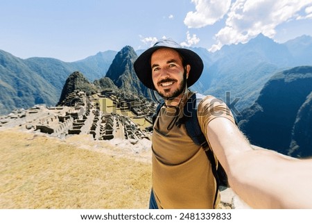 Similar – Image, Stock Photo Male tourist with photo camera standing on rocky lake shore