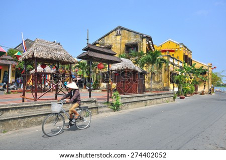 HOI AN, VIETNAM - MARCH 12: Woman rides a bike in Hoi An old town, Vietnam on March 12, 2015. Hoi An is a city of Vietnam, on the coast of the East Sea.