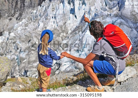 Man pointing out the glacier to the child