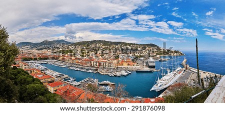 France, Nice, 2015: Port of Nice, top view, view from the castle park, a lot of boats, small boats, big white ship moored CLUB MED 2, the orange roofs of houses, a lot of houses on the hillside