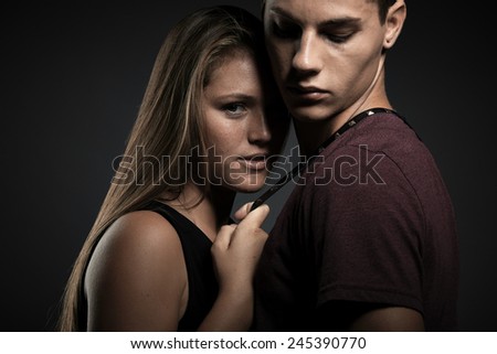 Portrait of beauty young couple against dark grey background