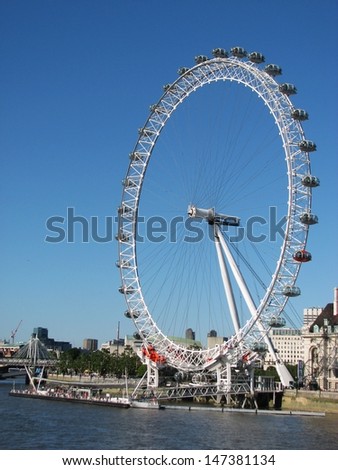 LONDON, UK - JUNE 26: London Eye and Thames river on June 26, 2011 in London, UK. The London Eye is a giant Ferris wheel on the South Bank of the River Thames in London, England.