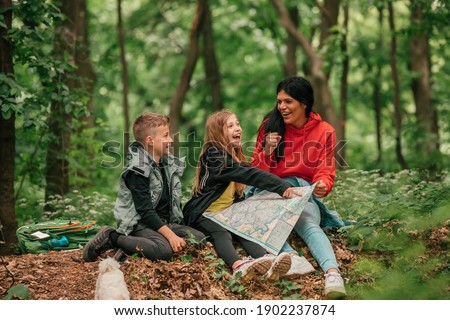 Similar – Image, Stock Photo Focused woman with map sitting near camping tent in nature