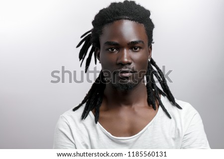 Similar – Image, Stock Photo Portrait of Handsome Black Man Turning Head Looking at Camera