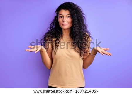 woman with curly black hair shrugging misunderstanding, portrait of emotional female isolated Foto stock © 