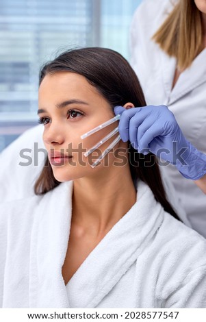 Side view close-up photo of young beautiful woman came to beautician to get PDO thread, Thread Lifting procedure. Aesthetic beauty anti aging, face lifting surgery. Chossing the best thread Stockfoto © 
