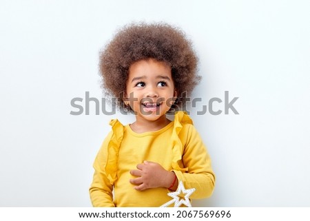 Similar – Image, Stock Photo A charming baby is watering a strawberry bush in the garden from a children’s toy watering can. Childhood, sun, summer, gardening