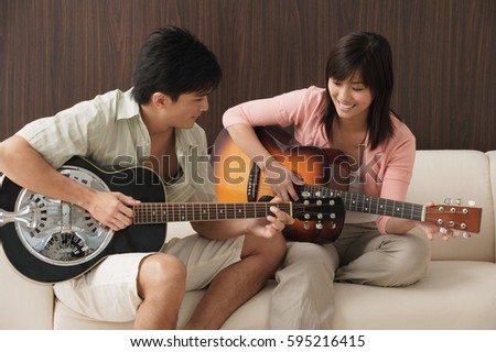 Similar – Image, Stock Photo Delighted ethnic couple playing video game together