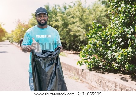 Similar – Image, Stock Photo Coronavirus garbage. Volunteers collecting used disposable medical masks and gloves near the bus stop and along the highway. The problem of environmental pollution during a pandemic COVID-19