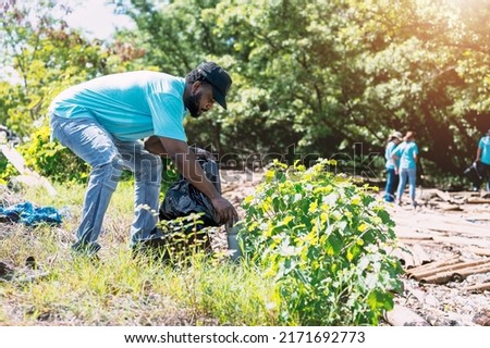 Similar – Image, Stock Photo Coronavirus garbage. Volunteers collecting used disposable medical masks and gloves near the bus stop and along the highway. The problem of environmental pollution during a pandemic COVID-19