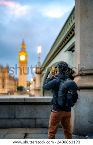 Similar – Image, Stock Photo Man shooting building facade with smartphone in downtown