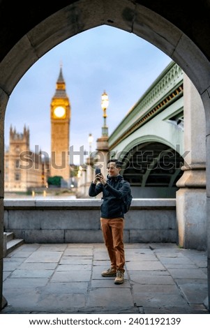 Similar – Image, Stock Photo Man shooting building facade with smartphone in downtown