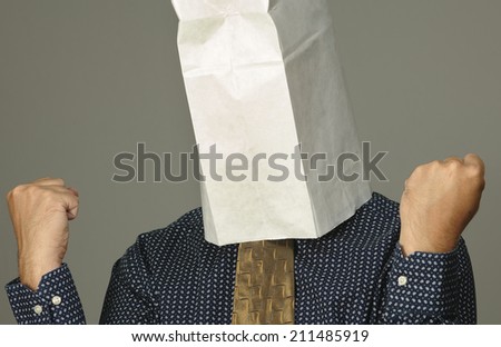 Frustrated businessman with a paper bag on his head