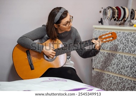 Similar – Foto Bild Zufriedene Frau spielt zu Hause Gitarre