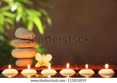 Stack of zen stones and aromatic candles on table,Zen concept.