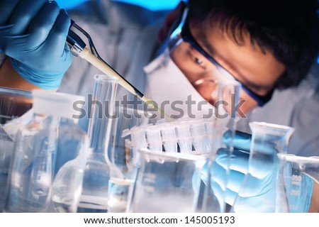 Scientist holds and examine samples